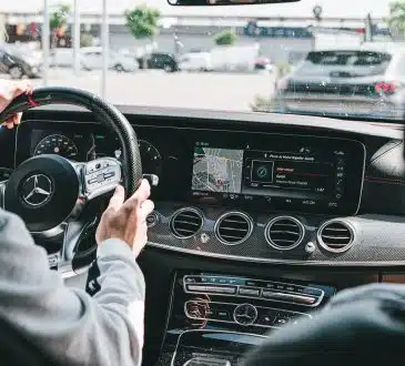 person in gray long sleeve shirt driving car