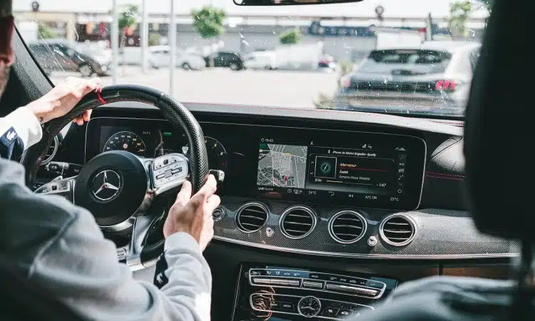 person in gray long sleeve shirt driving car