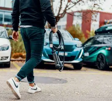 a man walking with a bike in his hand